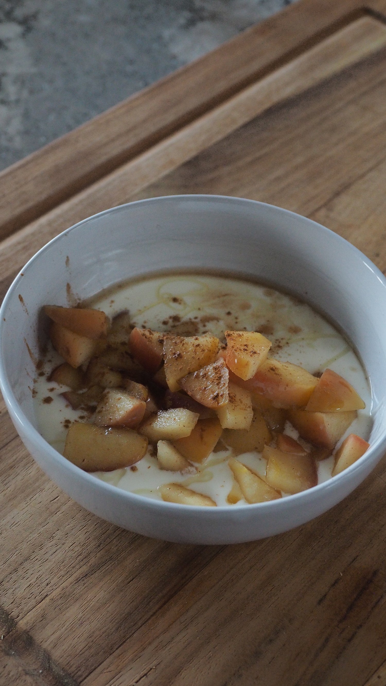 Bowl of yogurt with gut supportive apple compote with Bee Mafia Cinnamon honey